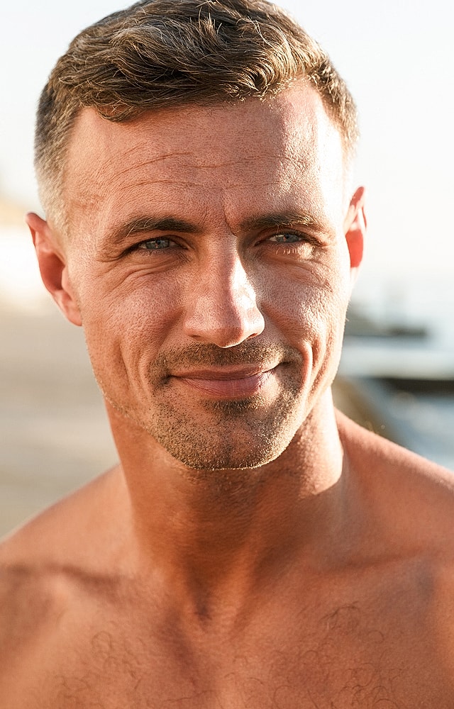 Smiling man outdoors with short hair