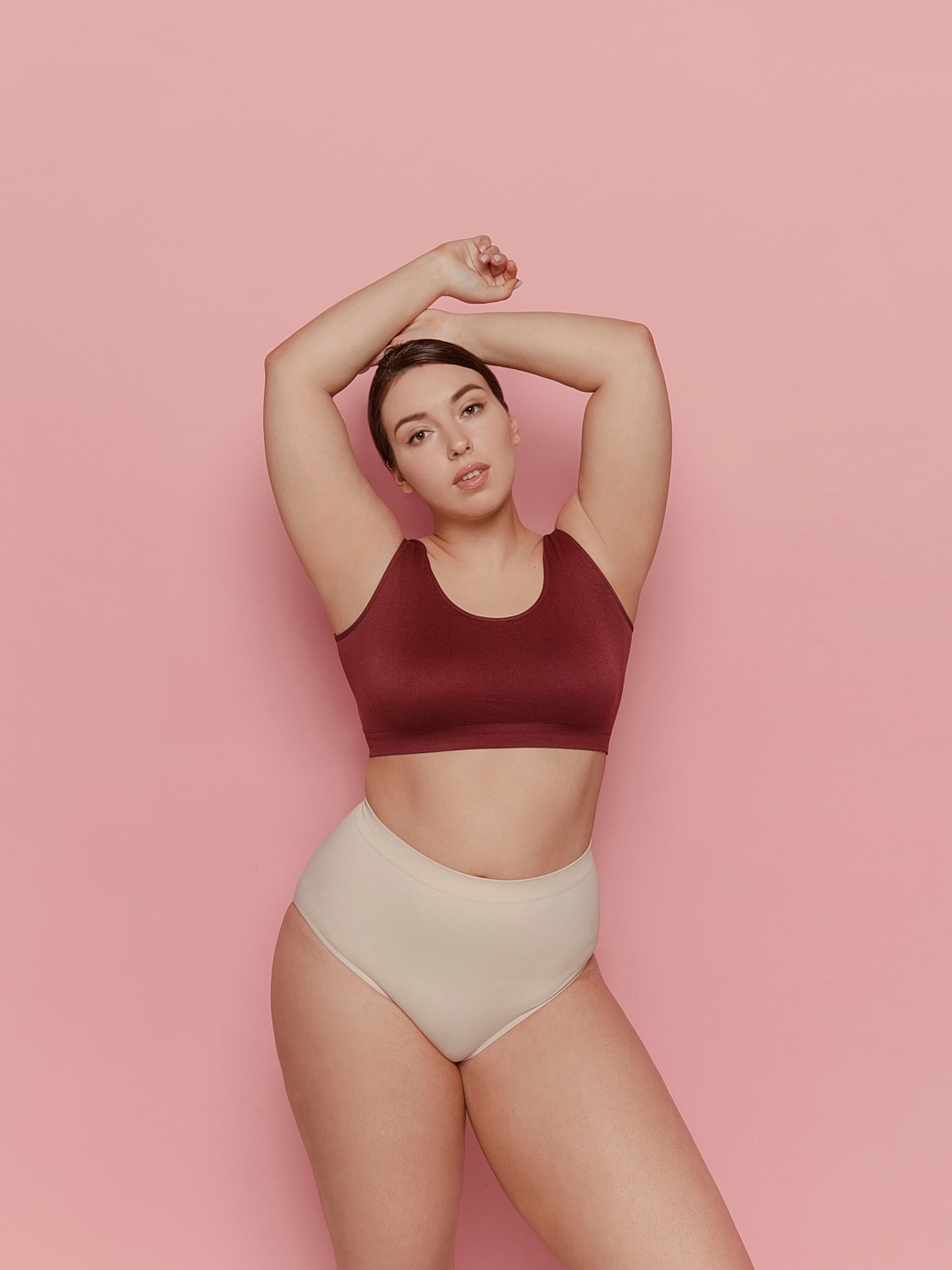 Model posing in crop top and high-waisted underwear.
