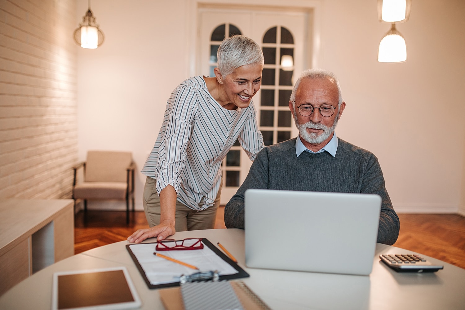 Senior couple engaging with laptop together.
