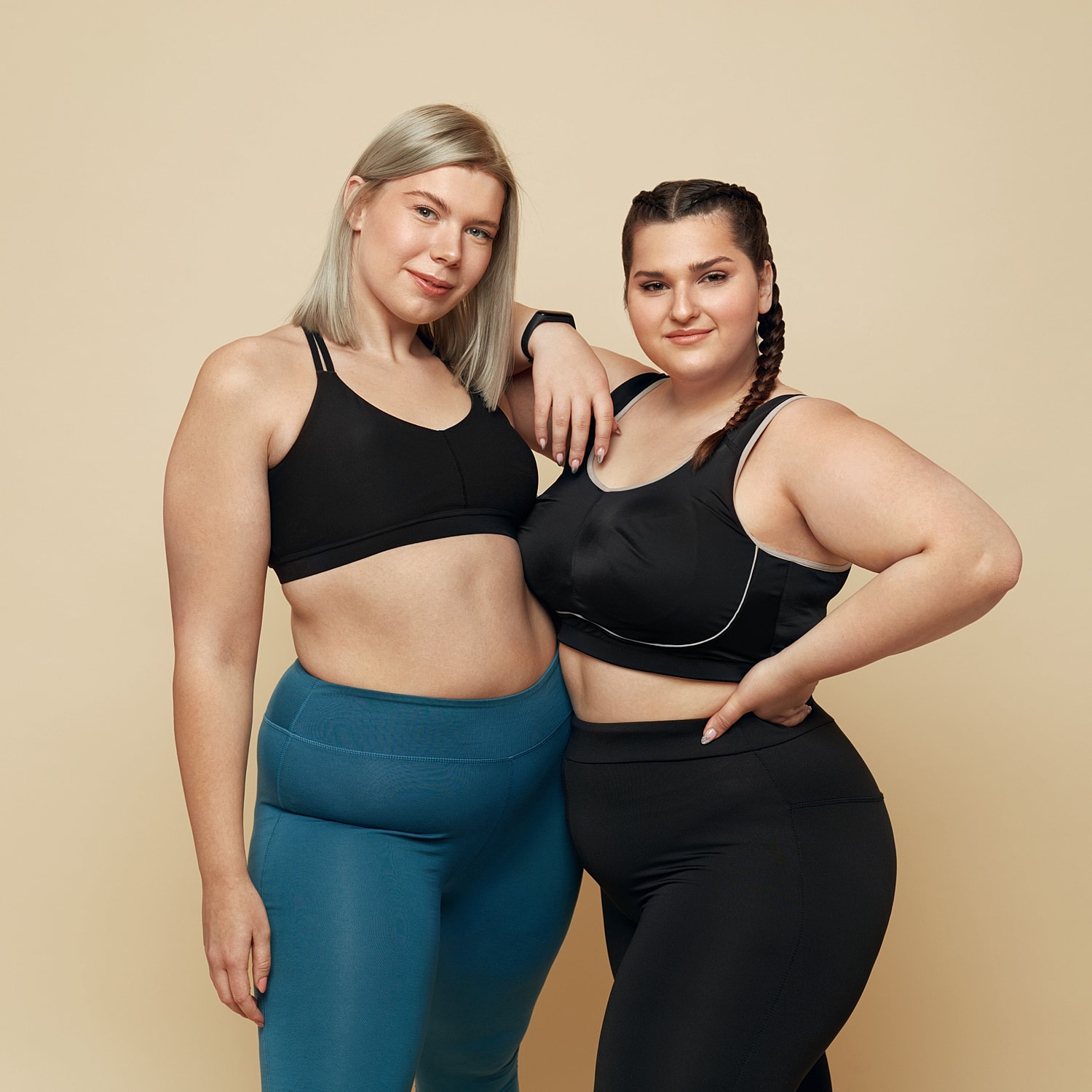 Two women in athletic wear posing together.