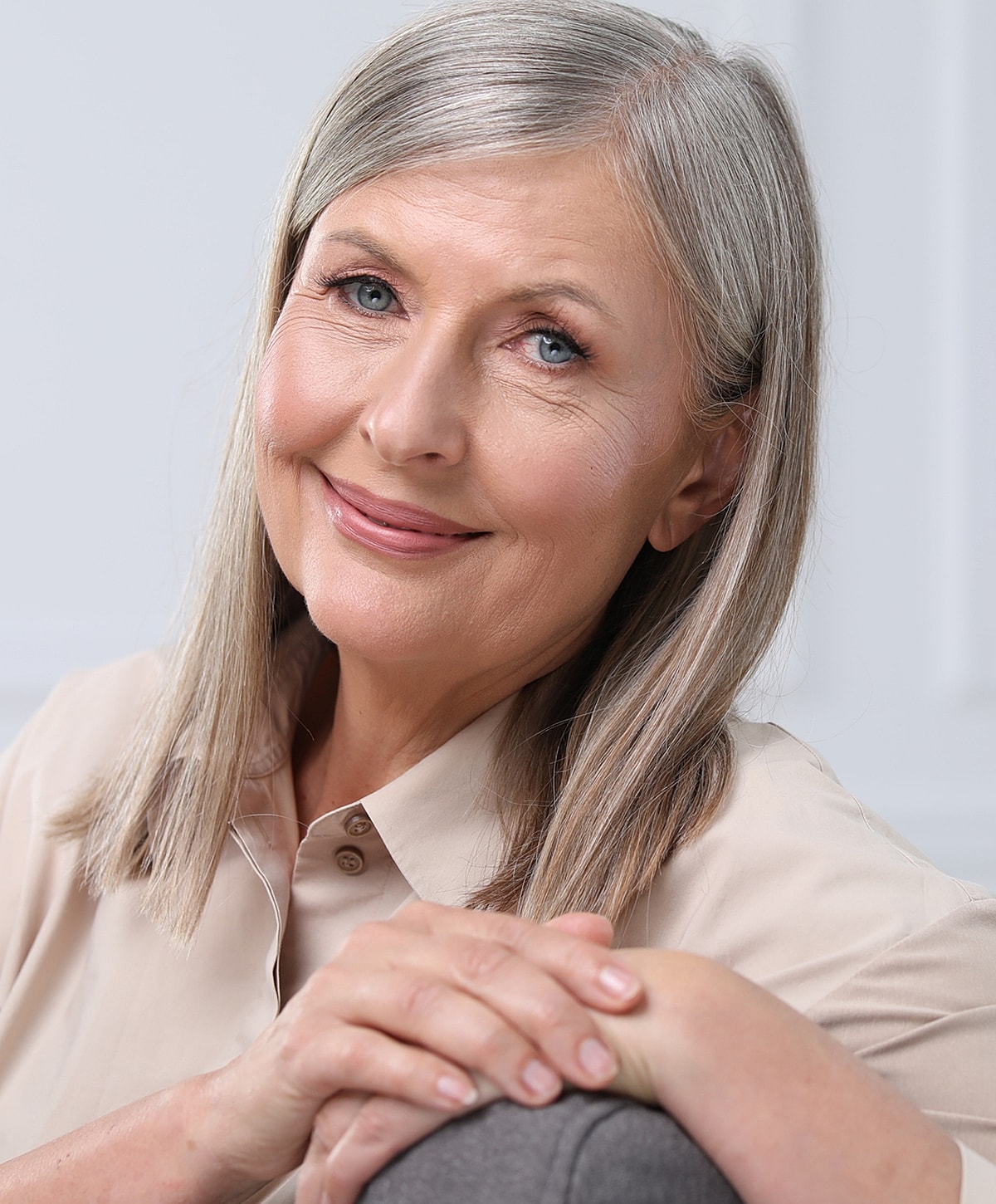 Smiling older woman with silver hair and soft expression.