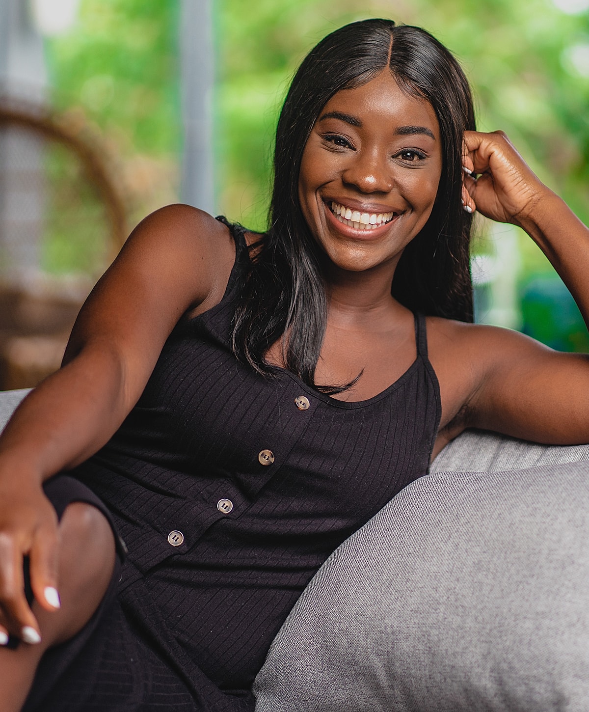 Smiling woman relaxing on a couch.